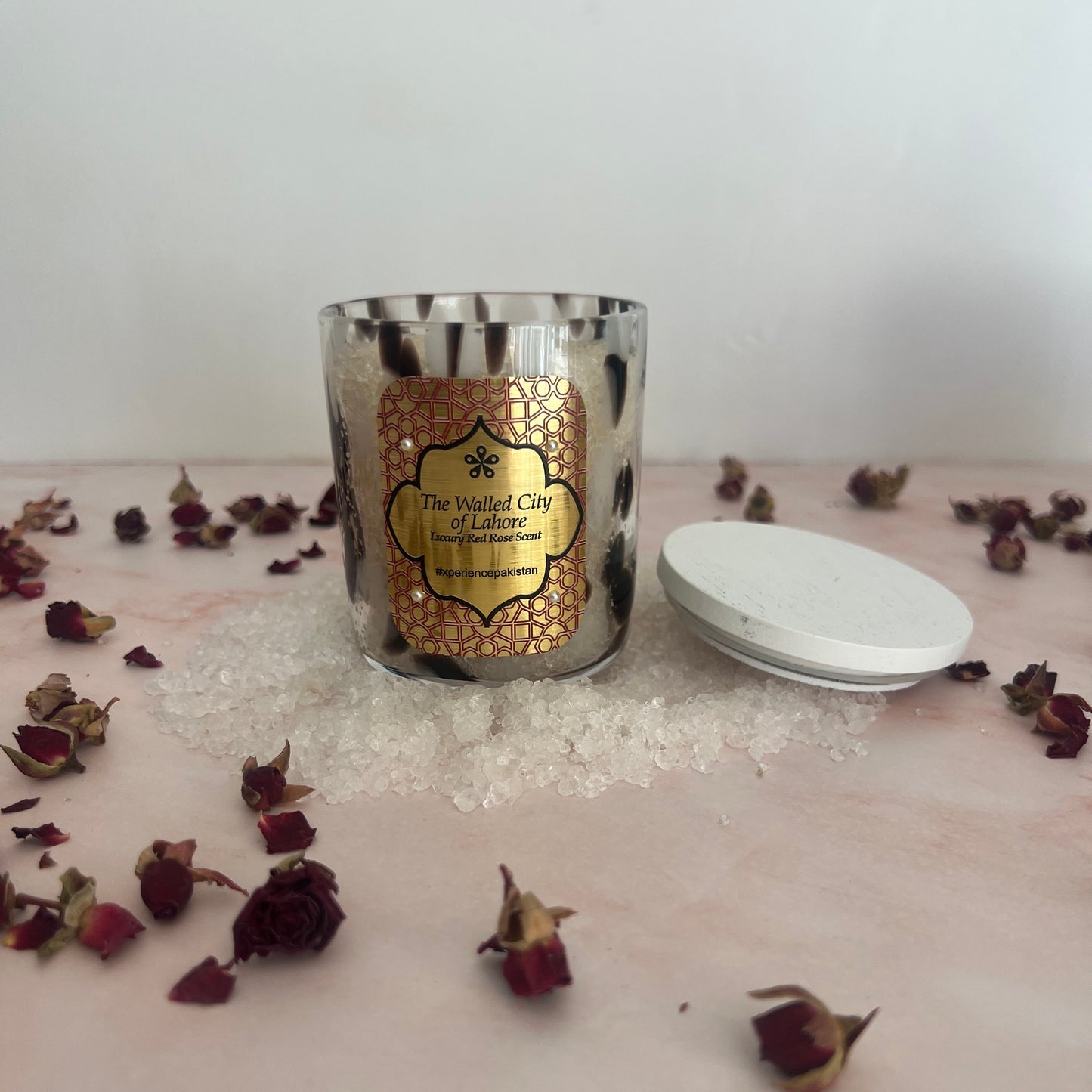 Bath Salts with decorative label on a white surface with dried flowers