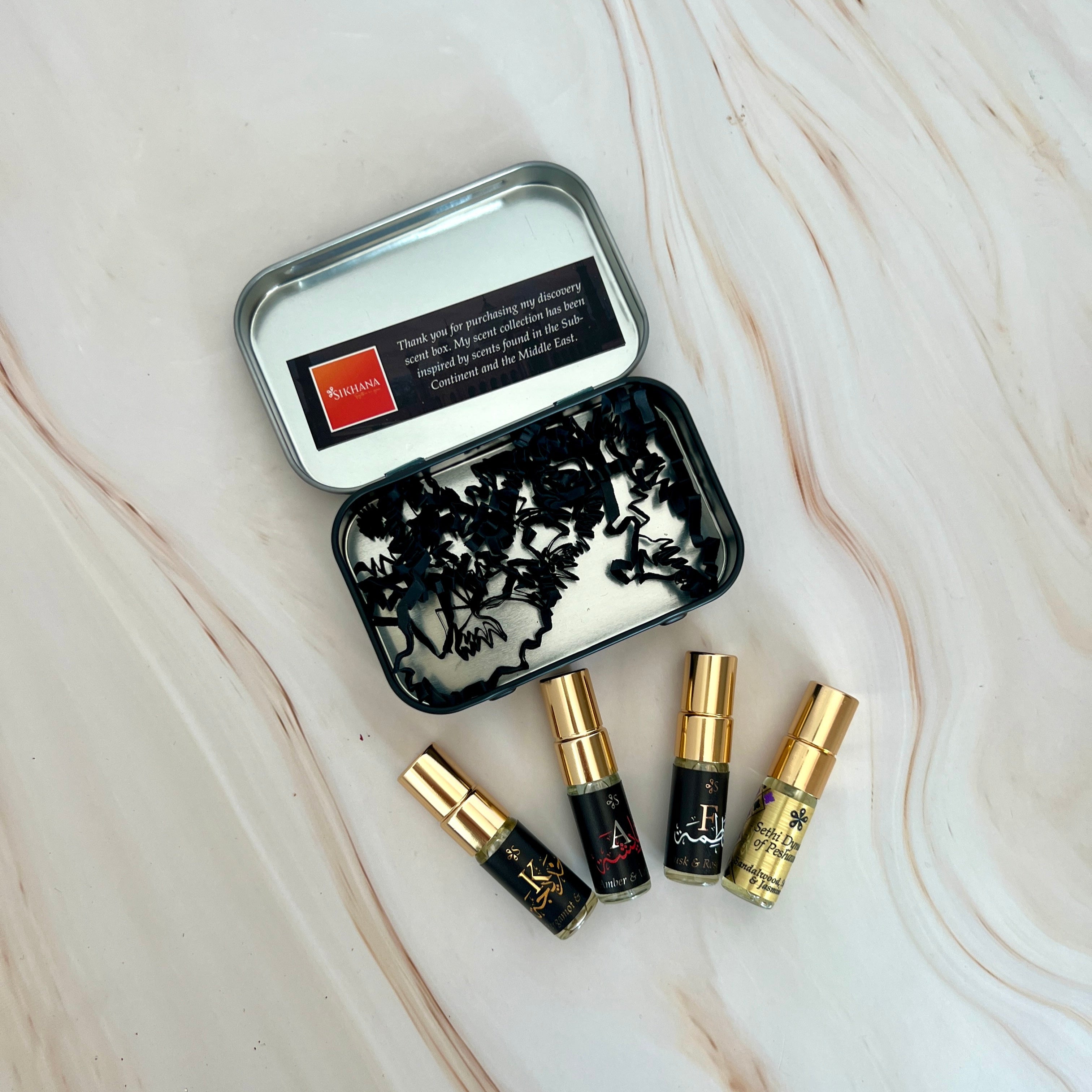Set of small bottles with gold caps on a marble surface