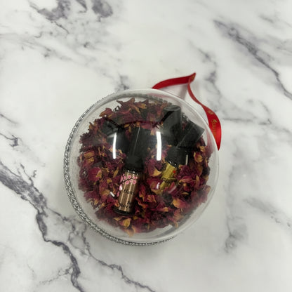 Clear jar with dried flowers and a red ribbon on a marble surface