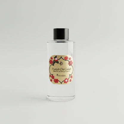 Bottle of Patrón El Diálogo blanco tequila on a reflective surface with a dark background