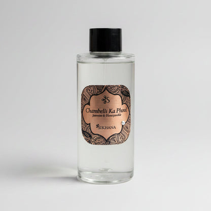 Small bottle with decorative label on a reflective surface