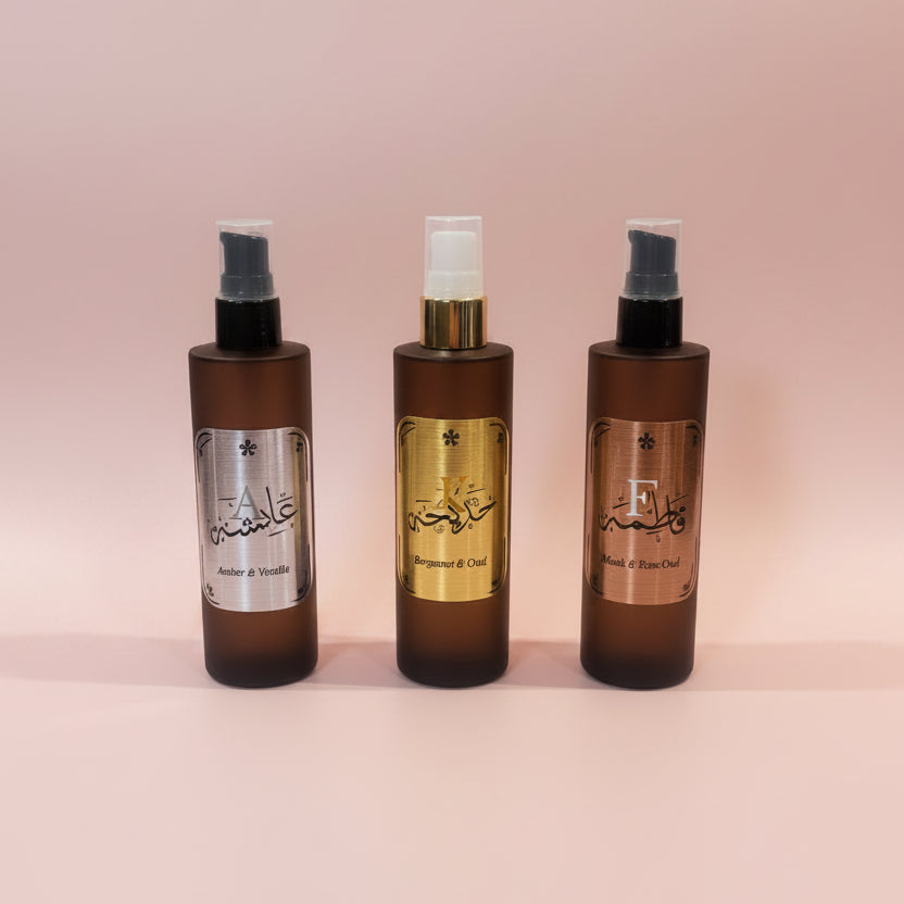 Three Body Oil bottles with visible branding on a marble surface.