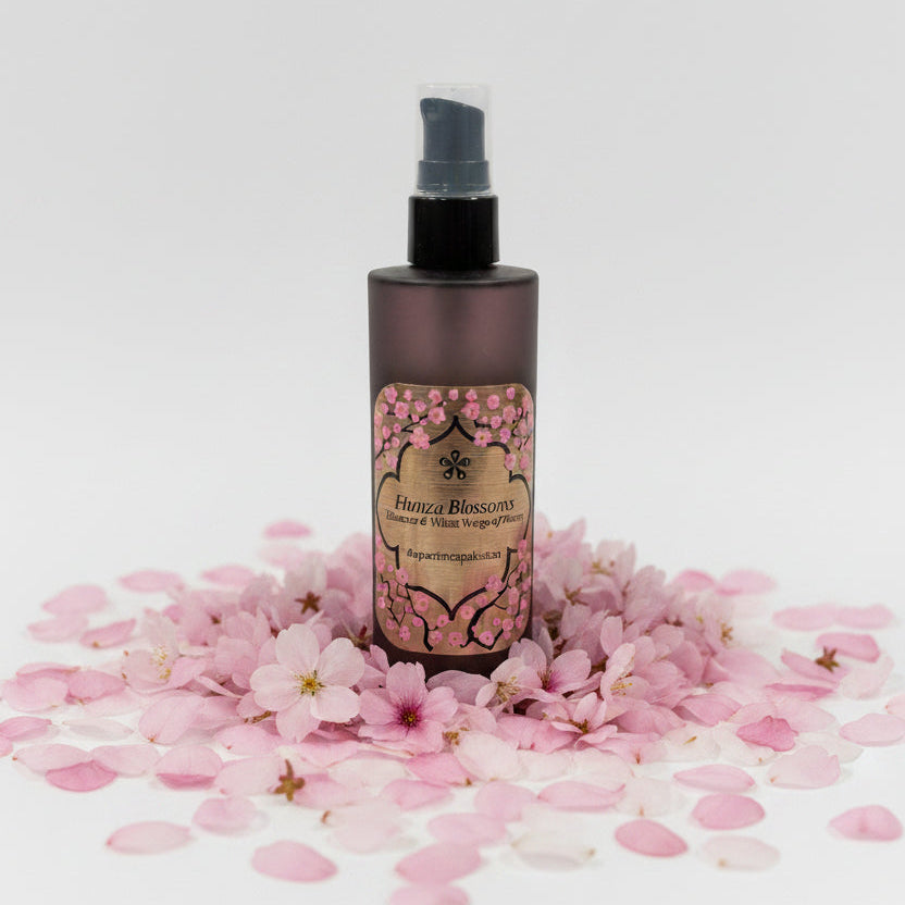 Brown spray bottle with decorative label on a marble surface