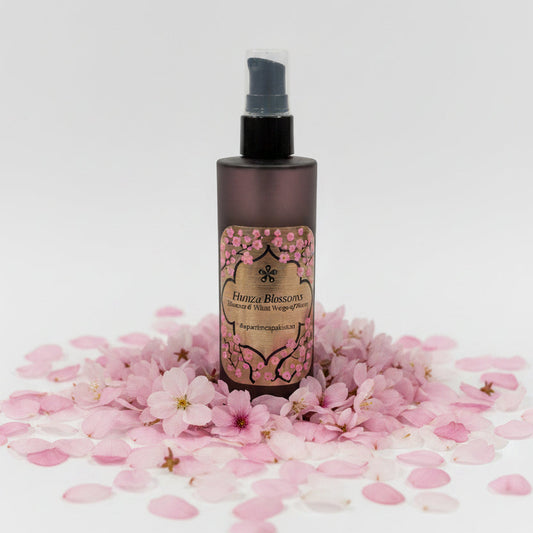 Brown spray bottle with decorative label on a marble surface