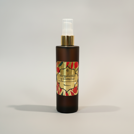 Black spray bottle with decorative label on a gray background