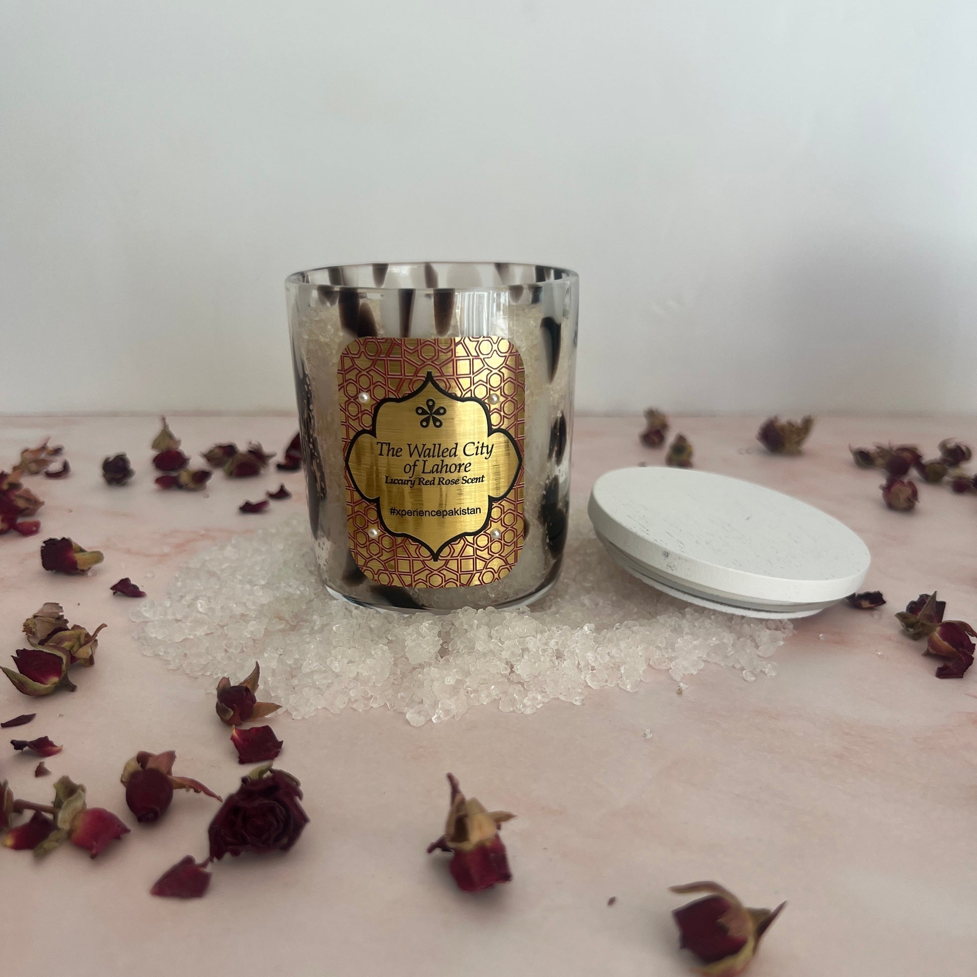 Bath Salts with decorative label on a white surface with dried flowers