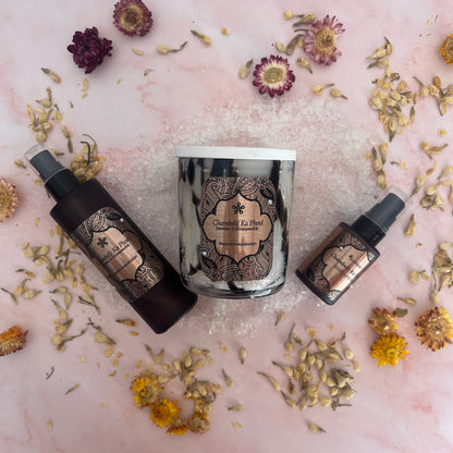 Bath Salts, Body Oil and Handcream with decorative labels on a pink surface with dried flowers