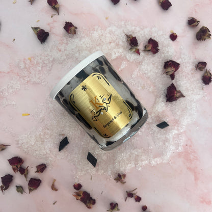 Gold and silver Bath Salts with dried flowers on a pink surface