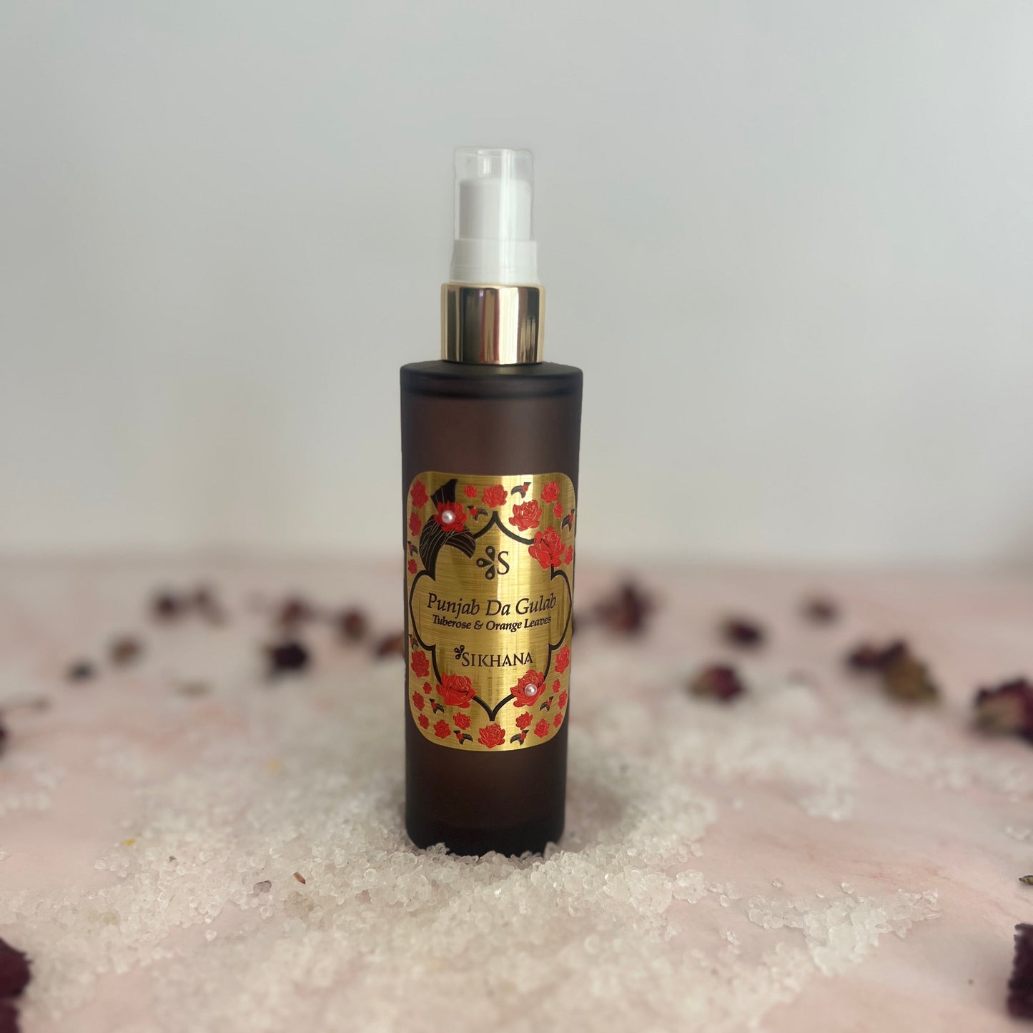 Skincare bottle with floral label on a textured surface