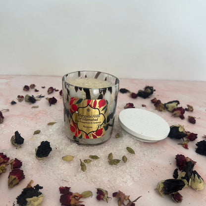 Bath Salts with floral design surrounded by dried flowers on a textured surface