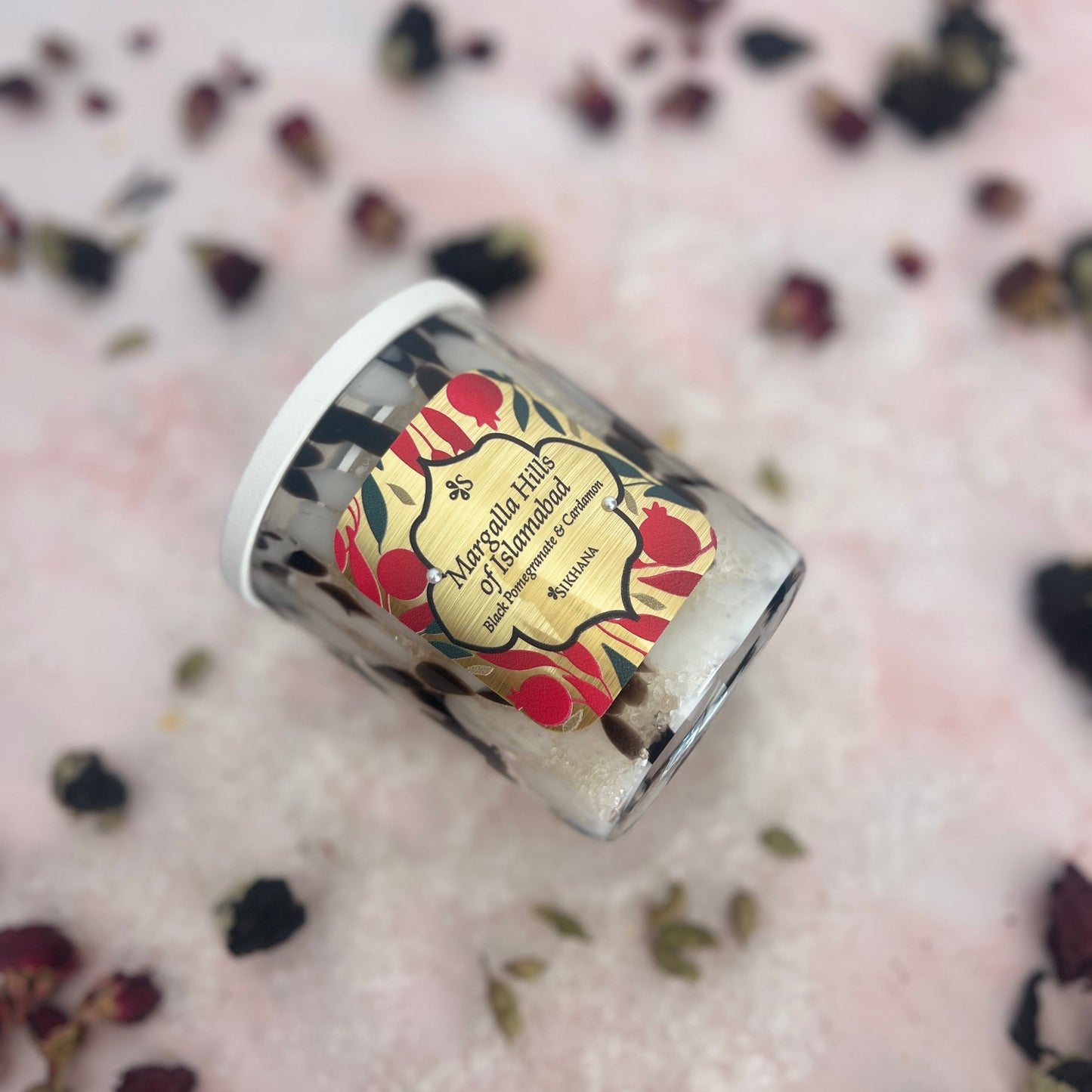 Bath Salts with a decorative label on a pink surface with dried flowers
