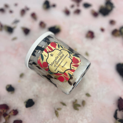 Bath Salts with a decorative label on a pink surface with dried flowers