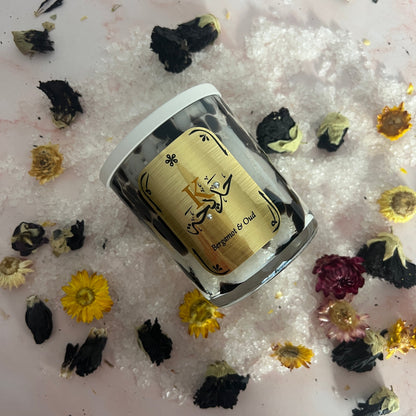 Bath Salts in a clear container with a decorative label on a surface with dried flowers.