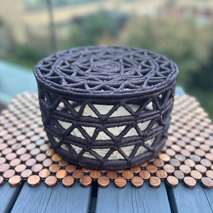 Black fruit basket made by artisans using date palm leaves