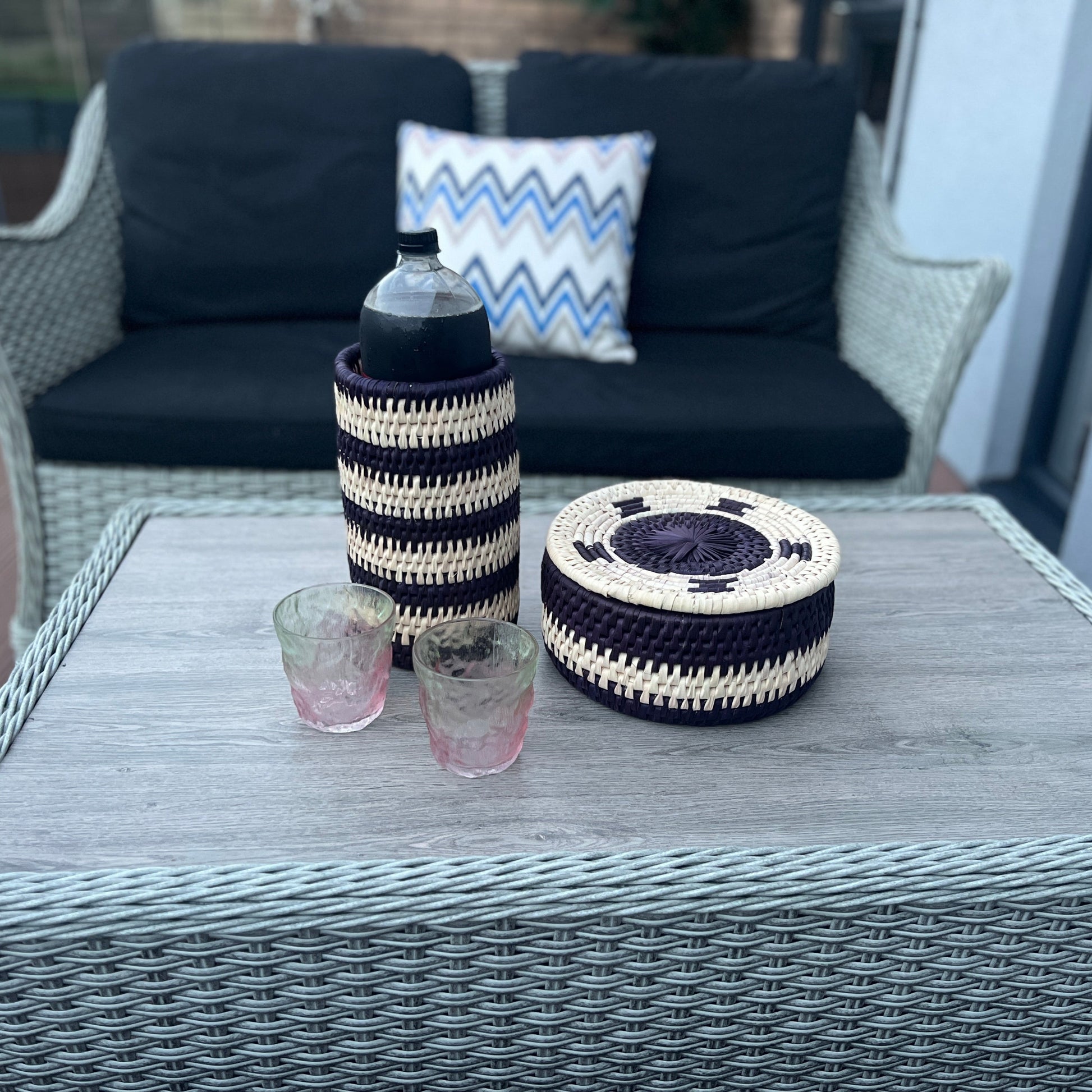 Black & white set of a hot pot & bottle holder made with date palm leaves by artisans in Sindh