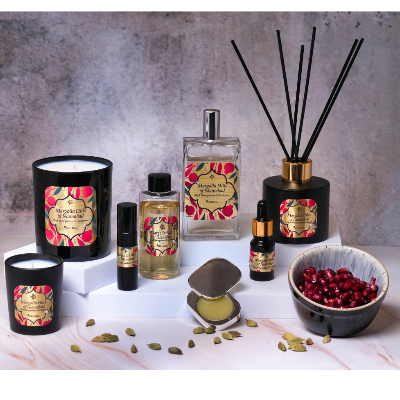 Collection of aromatherapy products including candles, diffusers, and essential oils on a textured surface.