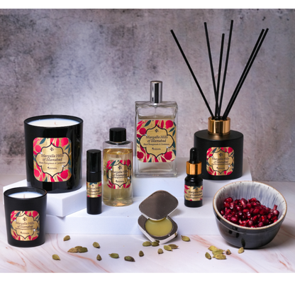Collection of aromatherapy products including candles, diffusers, and essential oils on a textured surface.