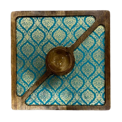 A square wooden serving tray with a carved gold-toned damask pattern insert and a central wooden bowl, shown from a top-down view on a white background.