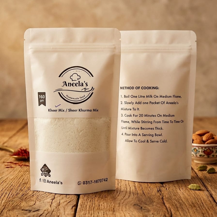 Two packages of Aneela's Dessert Mix on a wooden surface with a blurred background